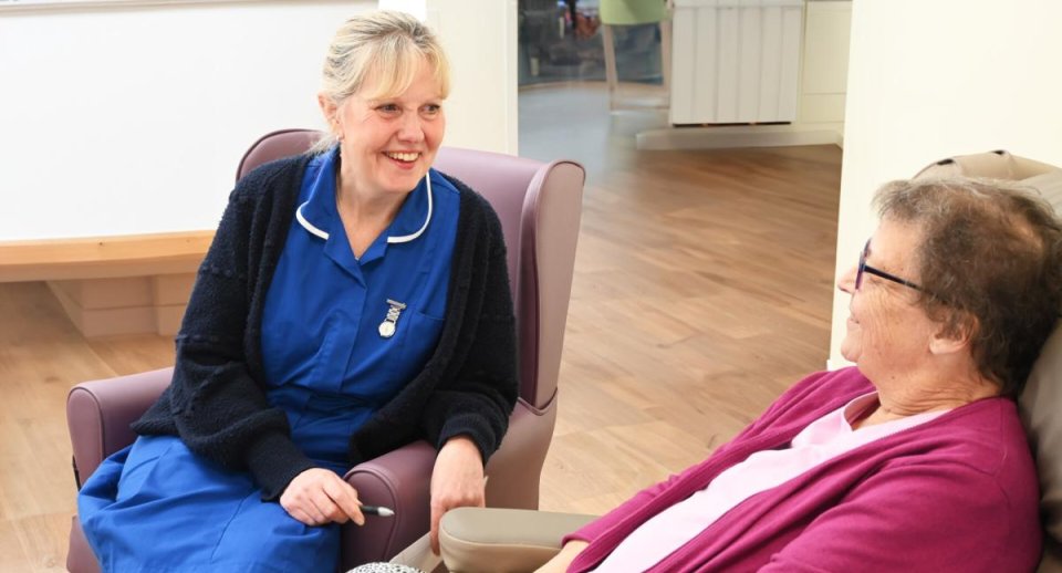 Hospice nurse talking to a patient